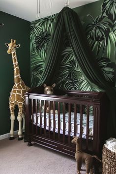 a baby's room with a giraffe, crib and stuffed animals