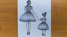 a drawing of a mother and daughter walking hand in hand on a piece of paper