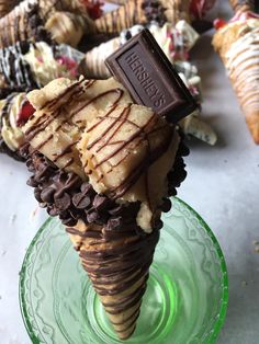 an ice cream cone with chocolate and cookies on top