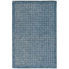 a blue rug with small squares on the bottom and one square in the middle, against a white background