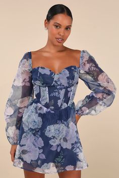 Curate an absolutely charming look in an instant with the Lulus Positively Enchanting Blue Floral Organza Bustier Mini Dress! Airy woven organza boasts a romantic floral print (in hues of blue, purple, and green) as it shapes a bustier-inspired bodice with supportive boning, seamed cups, and a sweetheart neckline (with hidden no-slip strips), framed by semi-sheer, long balloon sleeves with elasticized shoulders and cuffs. Basque-style waist tops a flowy, skater mini skirt, while a trendy lace-up Knot Tie Dress, Floral Organza Dress, Bustier Mini Dress, Romantic Floral Print, Organza Dress, Long Balloons, Purple And Green, Tie Dress, Dress Lace