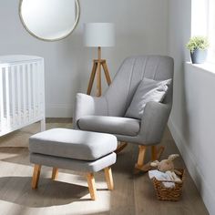 a baby's room with a rocking chair and foot stool