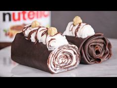 there is a roll that has chocolate and nuts on it, sitting on a table