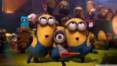 two minion characters hugging each other in front of a group of minions from the movie despicables