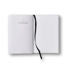 an open notebook with black ribbon on the cover and white paper in front of it