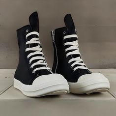 Elevate your footwear collection with the timeless style of Rick Owens Black Unisex Boots. These boots are a testament to the essence of Rick Owens fashion, blending elegance and comfort seamlessly. Whether you're seeking casual lace-up black shoes, genuine leather boots, or canvas shoes, these boots are the perfect gift for anyone who appreciates distinctive style. Key Features: Style: Embrace a concise and timeless style with these boots, making them versatile for various occasions. Heel Height: These boots feature a low (1cm-3cm) heel, offering comfort without sacrificing style. Fit: Designed to fit true to size, these boots provide a comfortable fit that embraces your feet's natural contours.   Take your normal size for the perfect fit. Handmade: Yes, these boots are handmade, ensuring Punk Style Leather High-top Sneakers, Leather Boots With Vulcanized Sole And Round Toe, Lace-up Boots With Stitched Sole For Streetwear, Leather Sole High-top Sneakers For Streetwear, Low-top Boots With Stitched Sole For Streetwear, High-top Sneakers With Leather Sole For Streetwear, Leather Rick Owens, Rick Owens Fashion, Rick Owens Boots