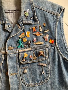 My well-loved and well-traveled Guess jean vest is ready for a new adventure. In the 1980s and '90s I slowly added souvenir pins from all kinds of places: Paris, Venice, Hawaii, LA. Chicken Boy, Pac Man, Felix the Cat and Gumby reside with promo pins for everything from the World Wildlife Fund to  safe-sex awareness. This is a truly unique artifact from the era, filled--or pinned--with memories. Chicken Boy, Jeans Vest, Felix The Cat, Well Traveled, Felix The Cats, Jean Vest, Pac Man, Vest Outfits, Guess Jeans