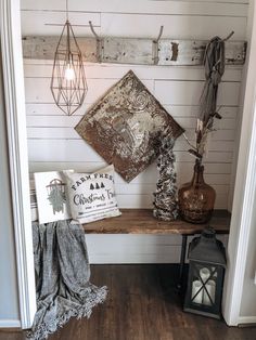 a wooden shelf with some decorative items on it and a lantern in the corner next to it