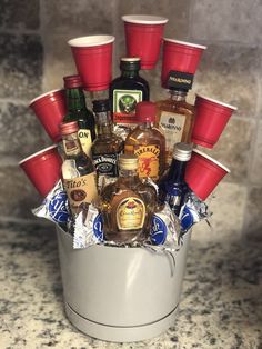 a bucket filled with liquor bottles on top of a counter