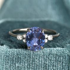 a tan and blue ring sitting on top of a blanket