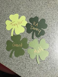 four leaf clovers with name tags attached to them