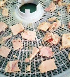 some meat is being cut into pieces on a grate with a saucer in the background