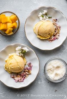 two plates with ice cream and mango slices