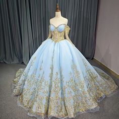 a blue and gold ball gown is on display