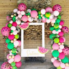 a photo frame made out of balloons and strawberries on the front of a building