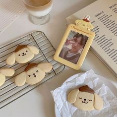 some cookies are on a cooling rack next to a book