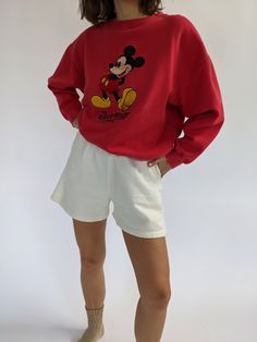 Vintage 90s nostalgic perfectly worn in Mickey Mouse pullover features a round neckline with micro ribbed detailing and an embroidered Mickey Mouse logo on the front. Perfectly paired with our waffled cotton shorts, your favorite ball cap, new balances, and your gold-toned jewelry. Tag reads Mickey Inc Subtle spots of lightening at the front middle. Casual Sweats With Embroidered Logo And Crew Neck, Casual Crew Neck Sweats With Embroidered Logo, Vintage Relaxed Fit Shorts For Streetwear, Casual Relaxed Fit Shorts With Ribbed Cuffs, Casual Crew Sweats With Embroidered Logo, Casual Sweats With Embroidered Logo, Casual Sweats With Embroidered Logo And Relaxed Fit, Casual Cotton Sweats With Embroidered Logo, Vintage Cotton Sweats With Relaxed Fit