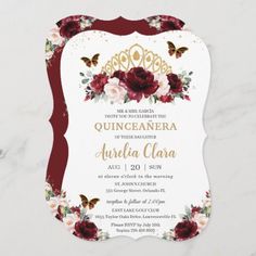 the burgundy and gold floral wedding card is shown on a white marble surface with an ornate frame