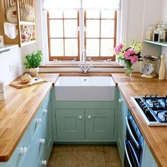 a kitchen with blue cabinets and wooden counter tops