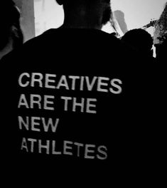 black and white photograph of a man wearing a t - shirt that says, creatives are the new athletes