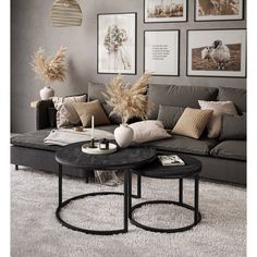 a living room filled with lots of furniture and pictures on the wall above it's coffee table