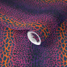 an animal print fabric with white circle on the center and purple, orange, and pink colors