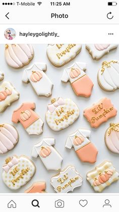 some cookies that are sitting on top of a white table and one is decorated with baby ones