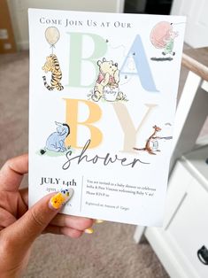 someone holding up a baby shower card with winnie the pooh and tigger on it