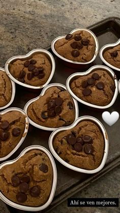 there are many heart shaped chocolate chip cookies in the pan