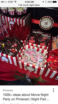 candy bar with red and white striped boxes filled with candies