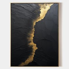 an abstract black and gold painting on the wall