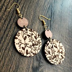 the earrings are made out of wood and decorated with flowers