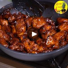 chicken wings being cooked in a frying pan