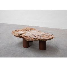 a table made out of marble with two brown bases on the top and one in the middle