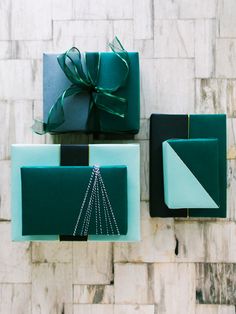 three boxes with green and black wrapping on them