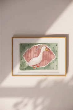 a watercolor painting of a duck on a white wall next to a wooden frame