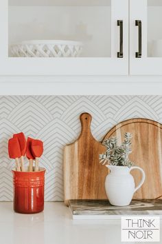 a wooden cutting board sitting on top of a kitchen counter