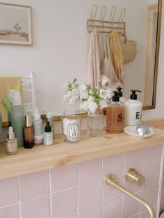 the bathroom counter is full of beauty products and personal care items, including hand sanitizers