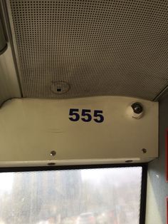 the number 555 is on the side of the window in this train car,