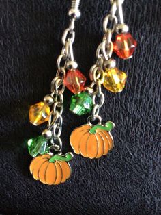 (13,034) Autumn Earrings  Made from stainless enamel, glass beads and stainless steel chain  A) Maple Leaf with Beads B) Pumpkin with orange, yellow and green beads C) Pumpkin with yellow, red and orange beads Orange Dangle Jewelry With Colorful Beads, Orange Czech Glass Dangle Earrings, Orange Drop Earrings With Dangling Beads, Orange Dangle Jewelry With Dangling Beads, Orange Dangle Jewelry With Lobster Clasp, Orange Czech Glass Beaded Jewelry, Orange Jewelry With Dangling Beads, Orange Beaded Chain Jewelry For Gift, Nickel-free Multicolor Enamel Jewelry