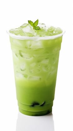 a green drink with ice and mint garnish