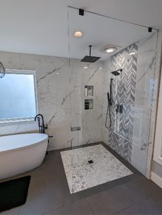 a large bathroom with a walk in shower next to a bathtub