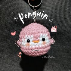 a crocheted key chain with a pink penguin on it