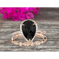 an engagement ring with a pear shaped black diamond