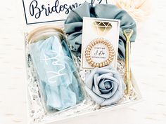 the bridesmaid gift set includes a blue rose, napkins and gold scissors