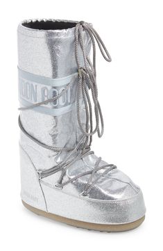 Break up the winter doldrums in cozy-glam style courtesy of this water-resistant, insulated Moon Boot doused with a shimmering flood of silvery glitter. The signature ambidextrous design and crisscrossing tubular laces keep you comfortable and secure no matter where your adventures lead. 14" shaft, 18 1/2" circumference (size 42) Lace-up style Drawcord-toggle cuff Water-resistant Textile and synthetic upper/synthetic lining/rubber sole Imported Ski Fits, Cozy Glam, Jean Skirts, Silver Boots, Metallic Boots, Classy Fits, 2024 Outfits, Glitter Boots, Moon Boot