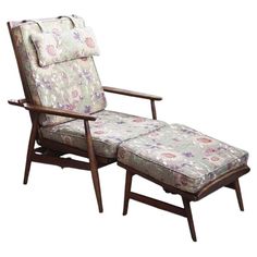 an upholstered chair and footstool with floral fabric