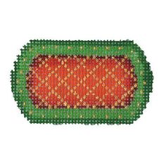 an orange and green beaded object on a white background, with gold dots in the middle