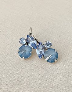 Gorgeous pair of drop earrings featuring 12mm and 6mm round, and 15x7mm Swarovski crystals in shades of blue.  Shown in the matte silver metal finish. Earrings are 1 1/4 inch long x 3/4 inch wide. Something Blue Crew, Light Blue Earrings, Blue Crew, Blue Bridesmaids, Wedding Jewelry Earrings, Blue Jewelry, Blue Earrings, Something Blue, Wedding Earrings