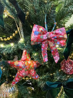 three bows are hanging on the christmas tree